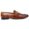 Brown leather loafer with a decorative buckle on a white background